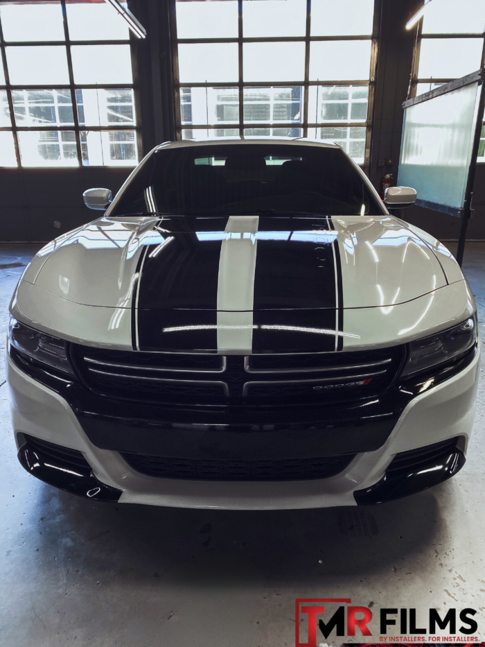 Sports car with clear glossy paint protection film for enhanced shine and surface protection.