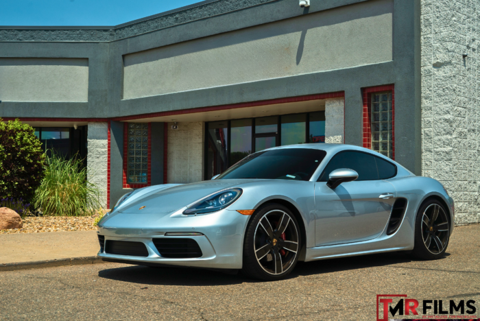 Silver Porsche with sleek window tint for enhanced privacy and UV protection.