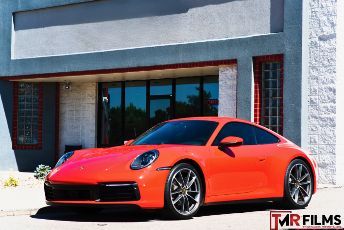 Orange Porsche with sleek window tint for enhanced privacy and UV protection.